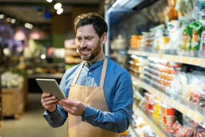 Retail employee checking a delivery against a purchase order on a tablet